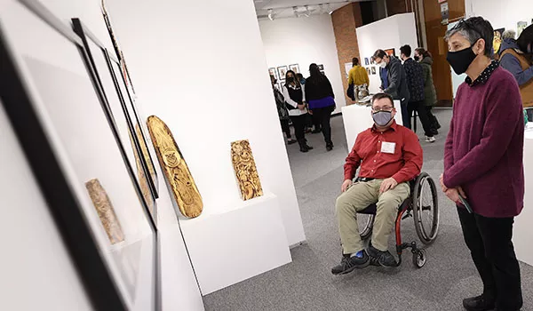 Opening reception attendees browse artwork in the Martin-Mullen Gallery.