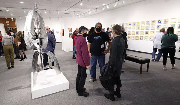 People admiring a sculpture