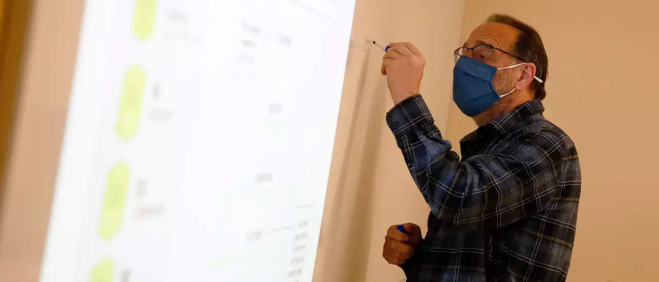 Professor working with students during lesson