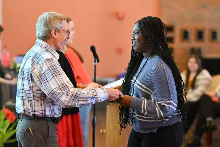 Jasmine Smallwood receives her membership certificate from Co-Advisor Ron Bishop