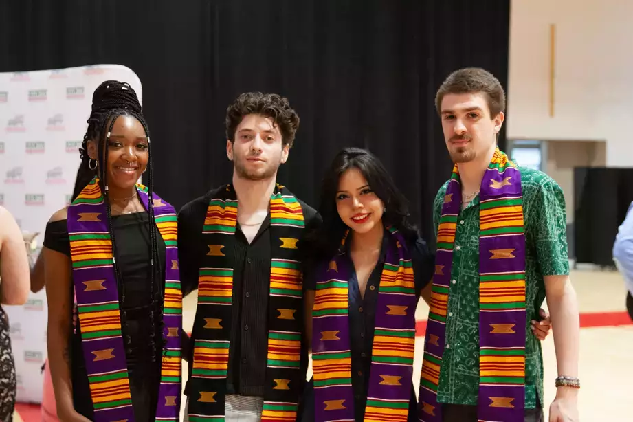 Four students donning the Kente stole during a Kente graduation 