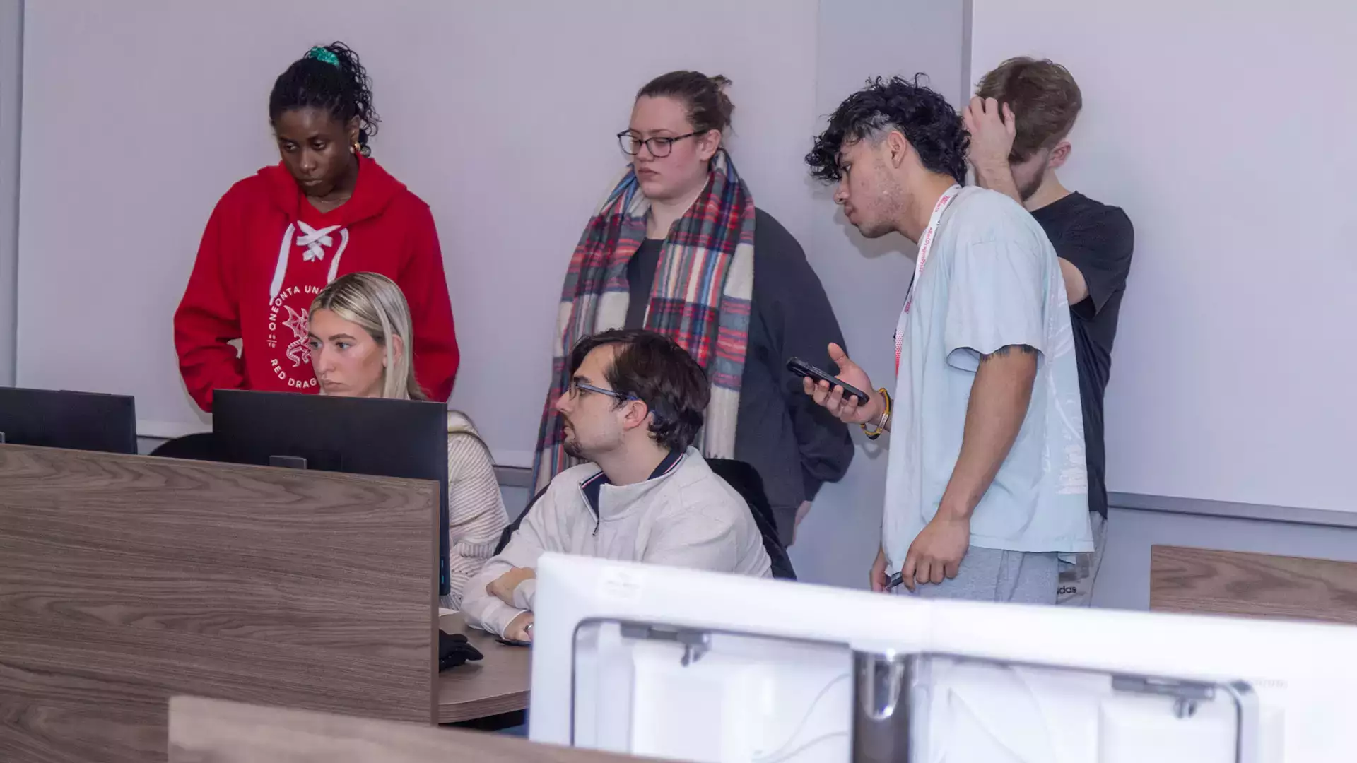 Members of the Accounting Society look over a member's work.