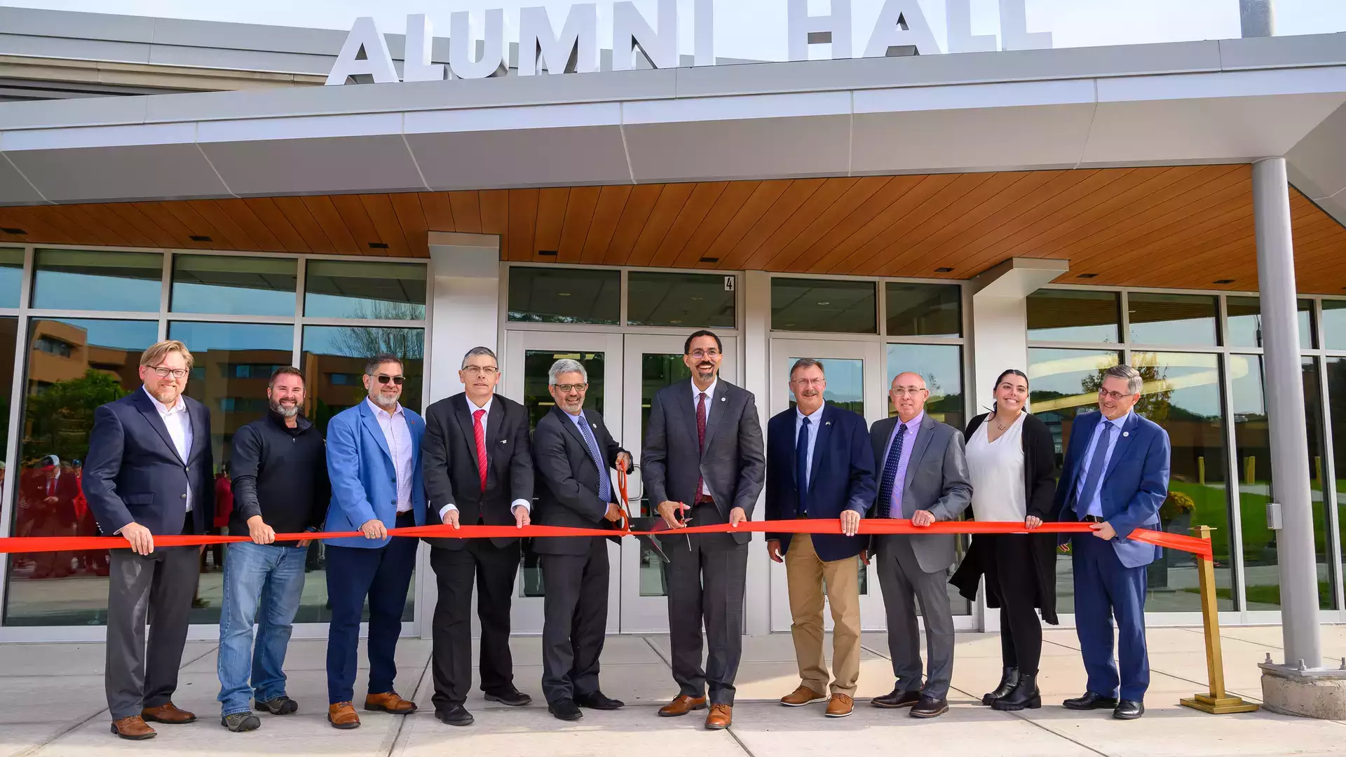 Ribbon cutting in front of rehabbed Alumni Hall, now a Platinum LEED-certified building