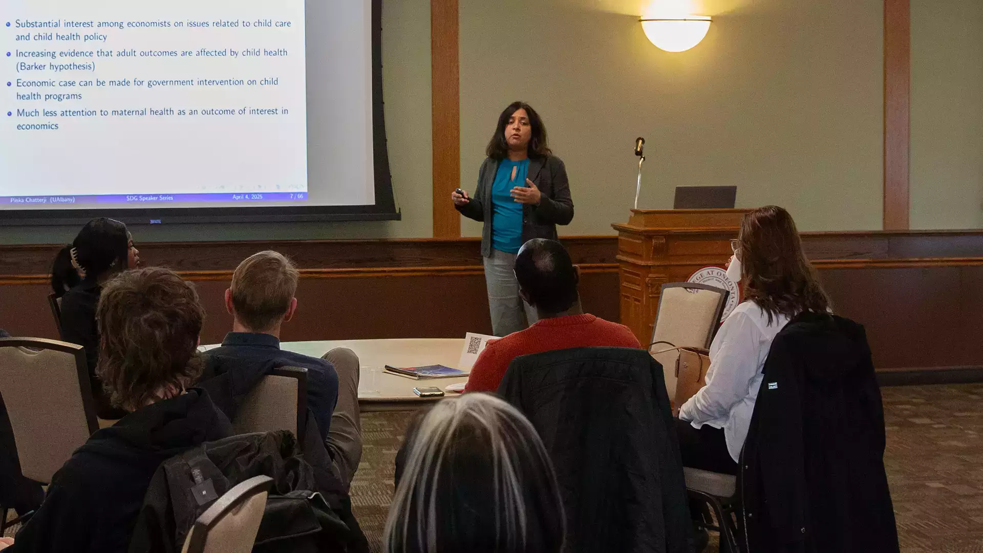 Speaker Pinka Chatterji, Ph.D., discussing economics and maternal health.