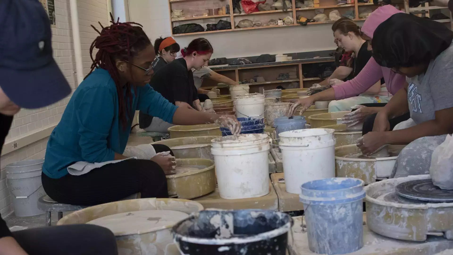 Students take part in a wheel throwing class and glazing demonstration.
