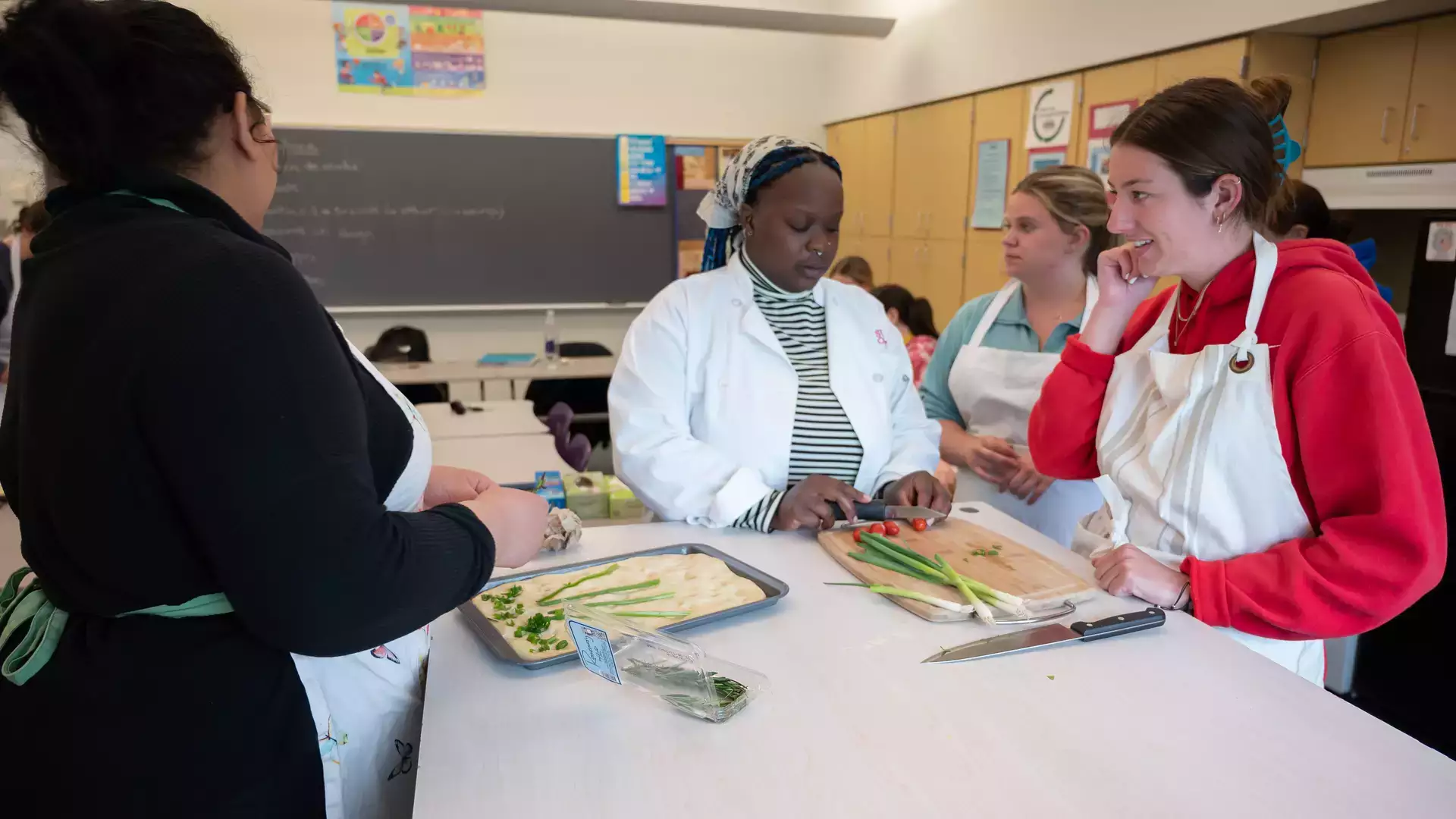 Students learning focaccia fundamentals as part of the Family and Consumer Science major.