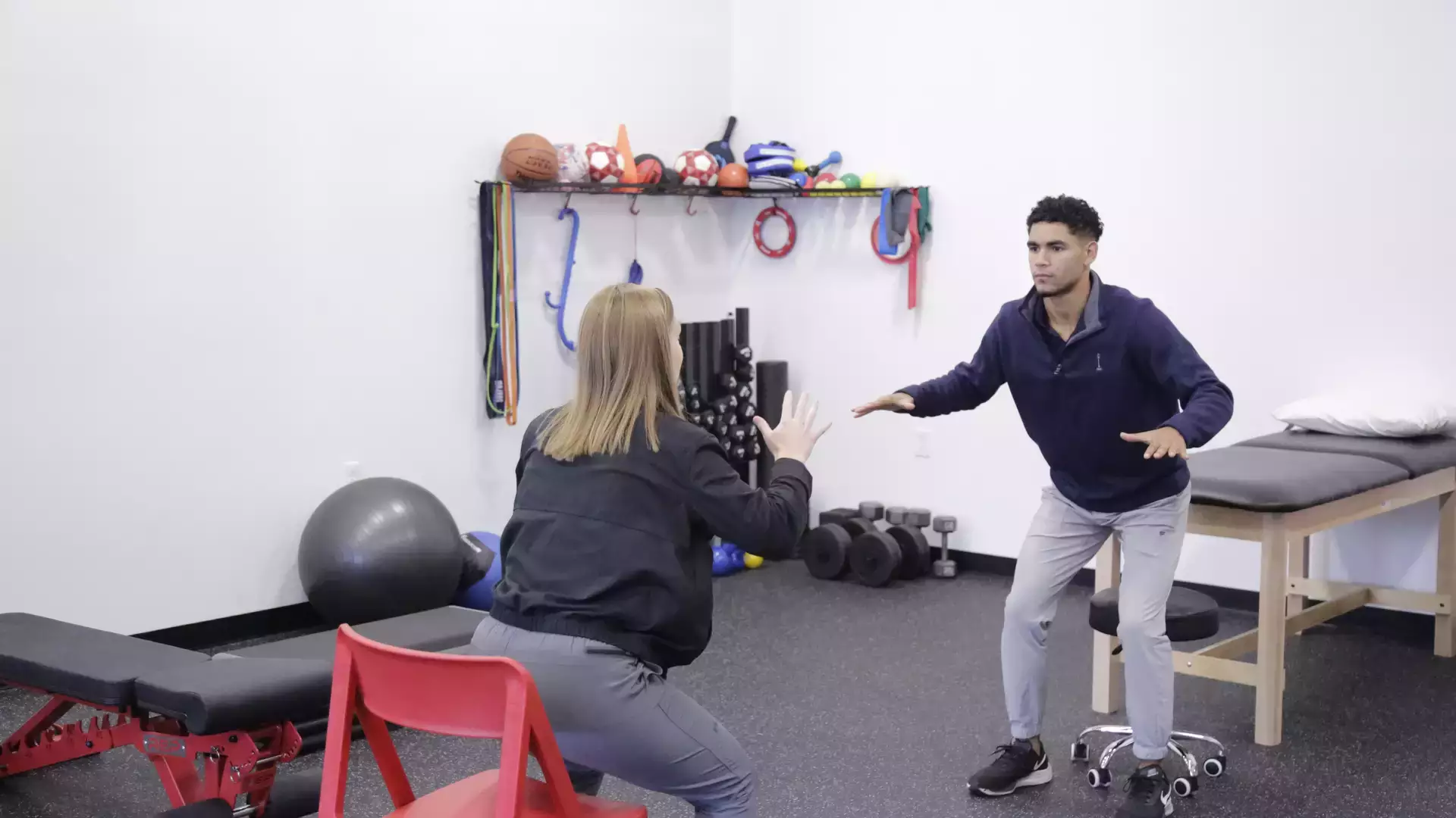 Dr. Chelsea Leah of Connect Physical Therapy demonstrates technique to intern Graham Wooden