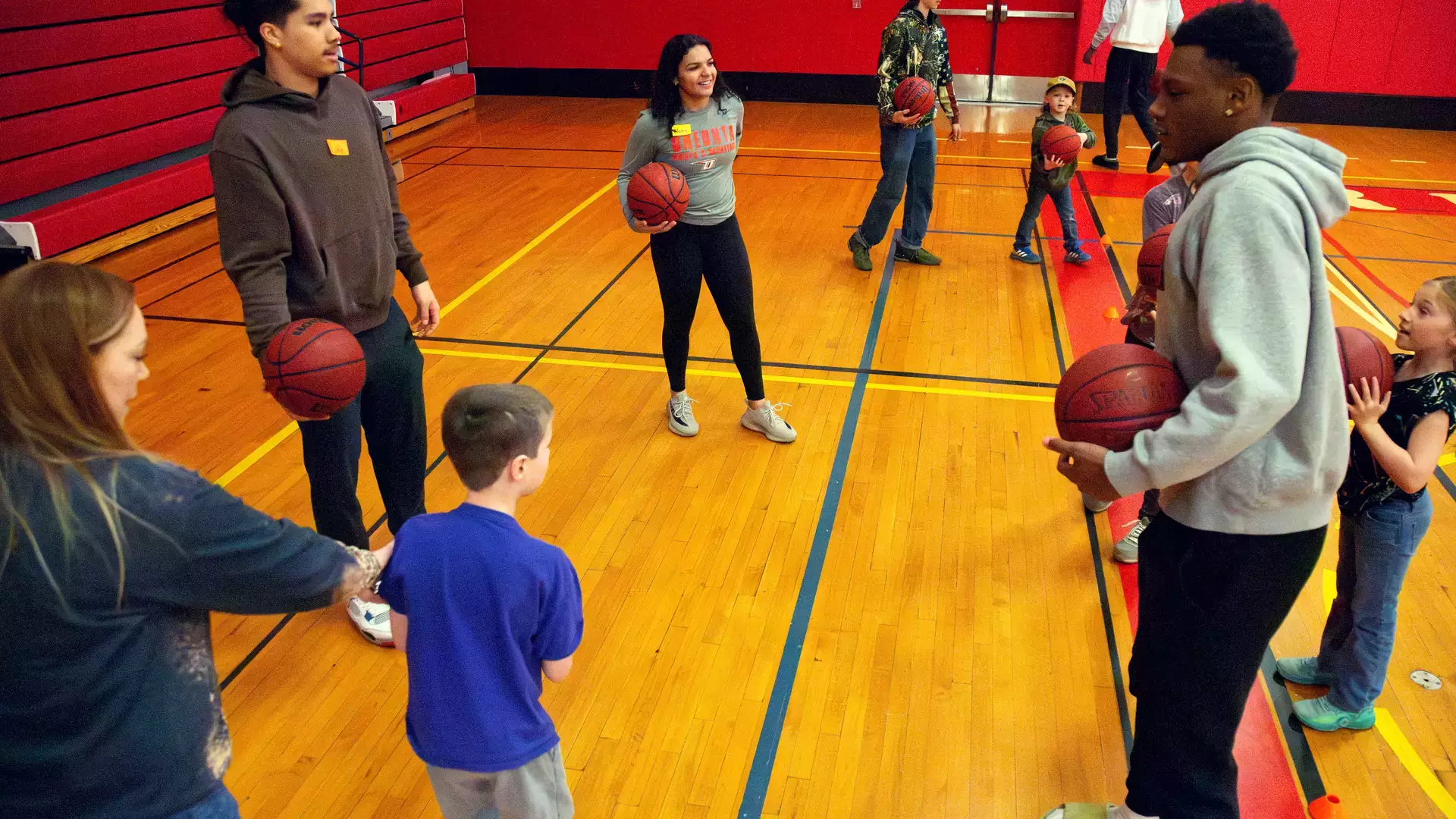 Exercise science students work in the EDD adaptive sports basketball clinic