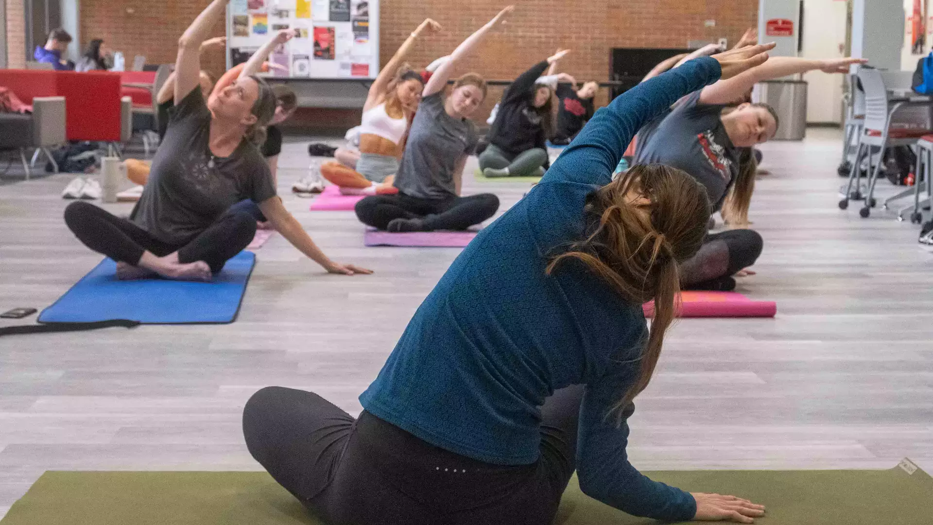 Yoga instructor facing practicing students