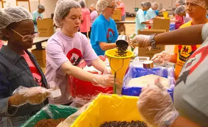 Students volunteer as part of 911 Service Day, creating meals for local food banks.